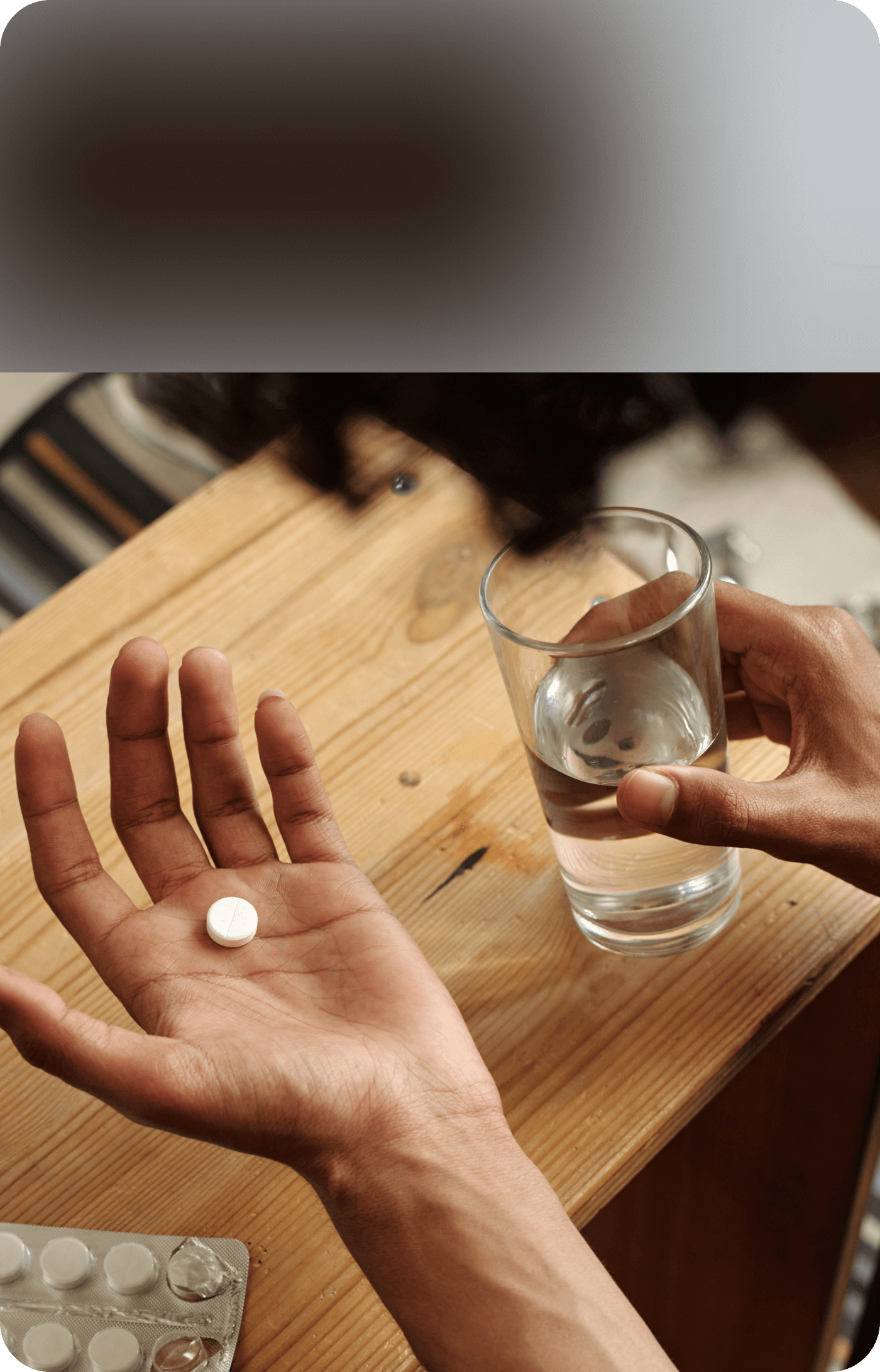 Holding pill and glass of water